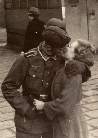 German soldier kissing his sweetheart goodbye.